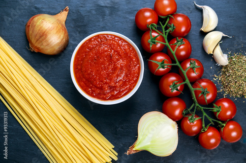 Ingredients for Spaghetti with marinara sauce.  Ready to Cook. On blue background photo