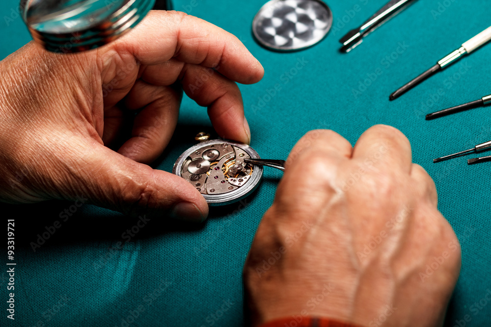 Pocket watch being repaired by senior watch maker, close-up. Pocket watch being repaired by senior watch maker, close-up.