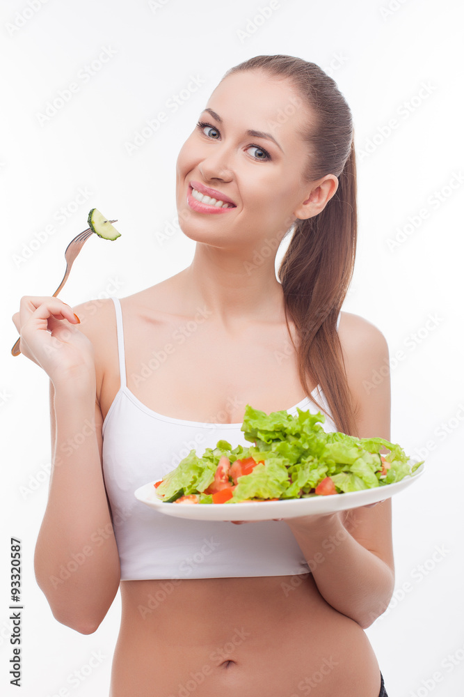 Cheerful fit girl is dieting with healthy food Cheerful fit girl is dieting with healthy food