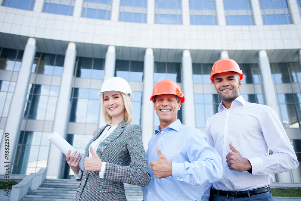 Cheerful construction team is working with joy Cheerful construction team is working with joy