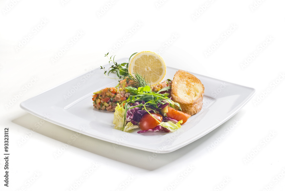 Salmon salad with vegetables and baguette on white background