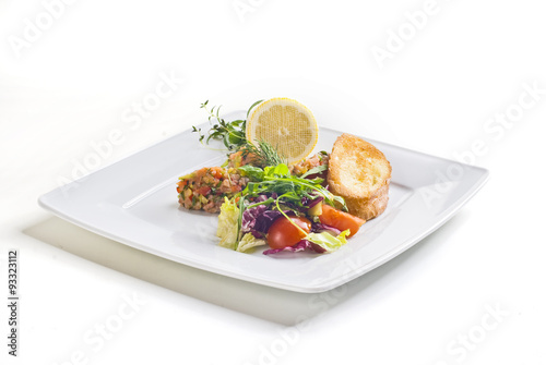 Obraz na płótnie Salmon salad with vegetables and baguette on white background w salonie