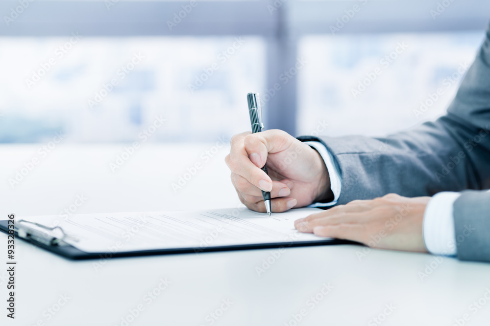 Business man signing a contract Business man signing a contract