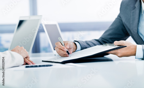 Female hand signing contract.