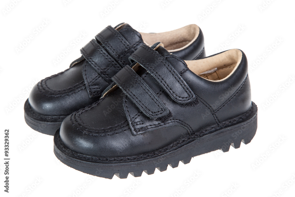 Cute child's black shoes, isolated on a white background Cute child's black shoes, isolated on a white background