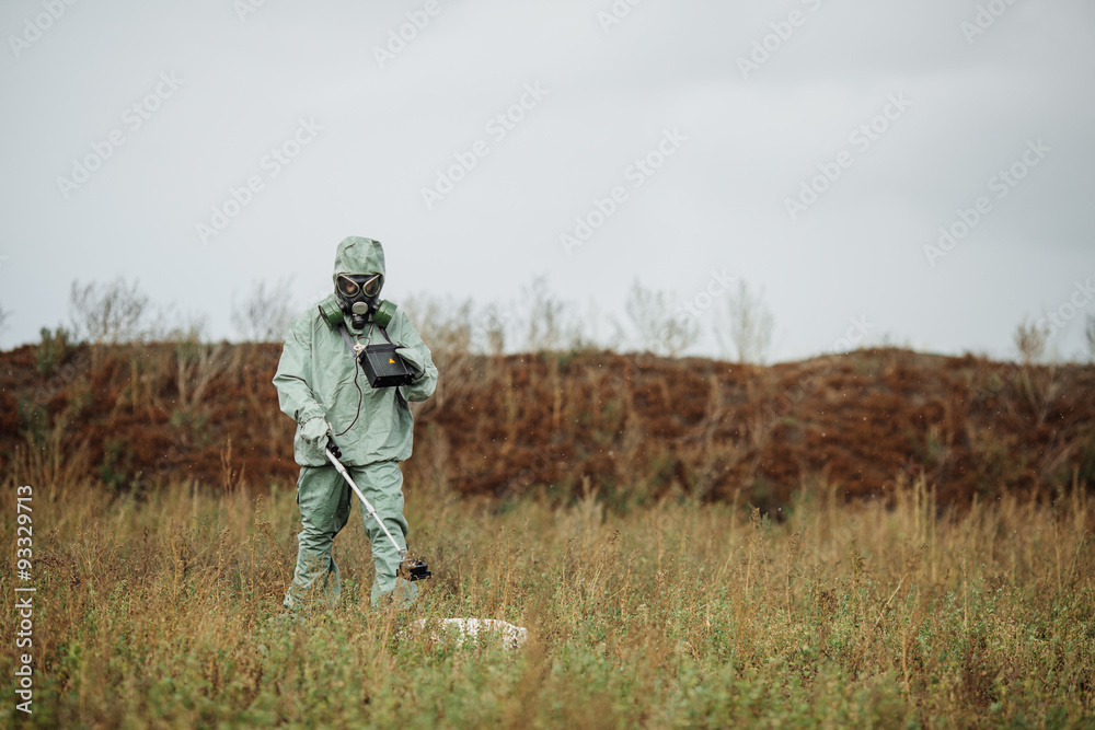 Scientist (radiation supervisor) in protective clothing and gas