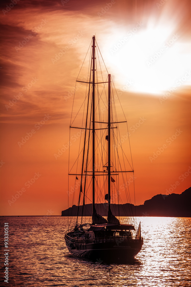Old ship sailing to the sunset.