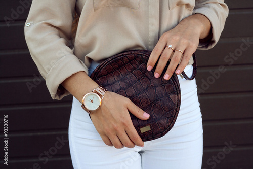 Trendy girl holding small brown leather bag handbag photo