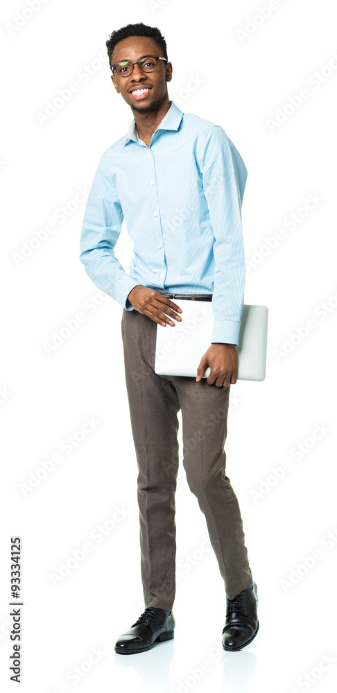 Happy african american college student with laptop standing on w Happy african american college student with laptop standing on w