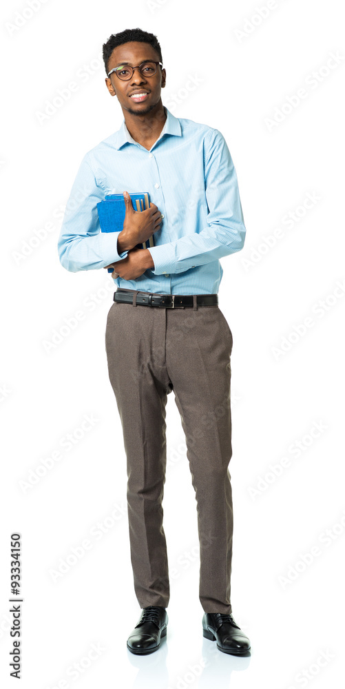 Happy african american college student standing with books in hi Happy african american college student standing with books in hi