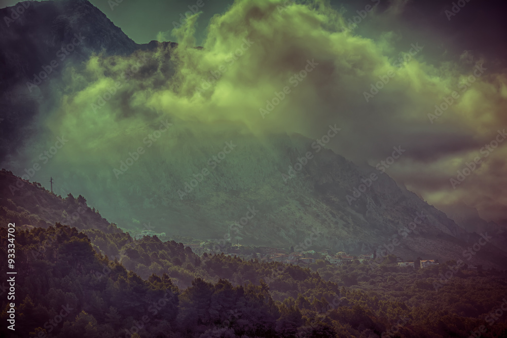Mystical mountain's village landscape with fog.
