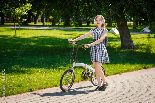 Young woman rides bicycle in the park