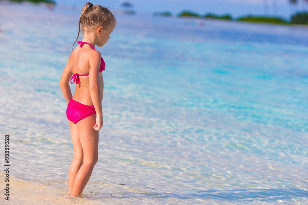 Adorable little girl at beach during summer vacation Adorable little girl at beach during summer vacation