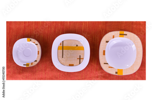 colored plates on a red tablecloth