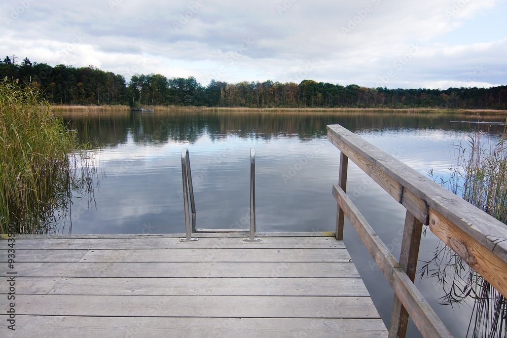 Wooden jetty and ladder into lake