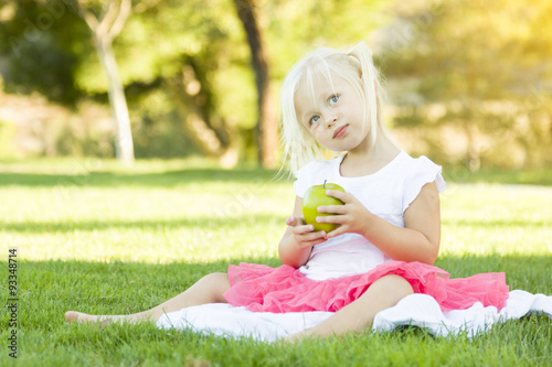 Little Girl In Grass Eating...
