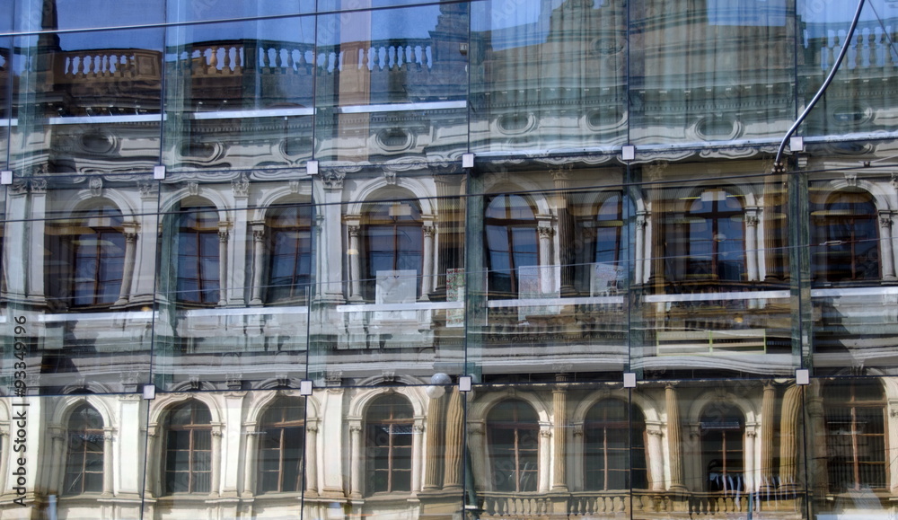 Reflections of Narodni Street in a glass wall of modern building