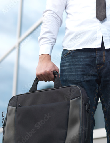 Detail of a businessman holding a briefcase