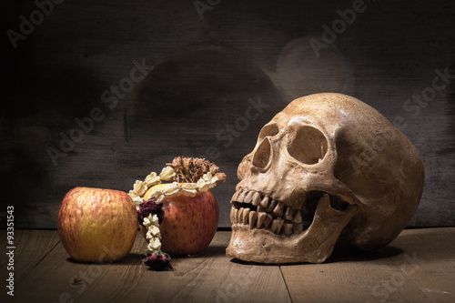 old skull and fruit still life on wooden board