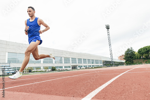 Attractive man Track Athlete Running On Track © santypan
