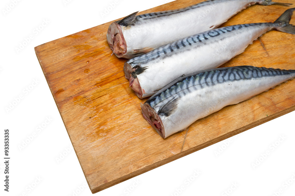 Three mackerel without head on a wooden Board isolated