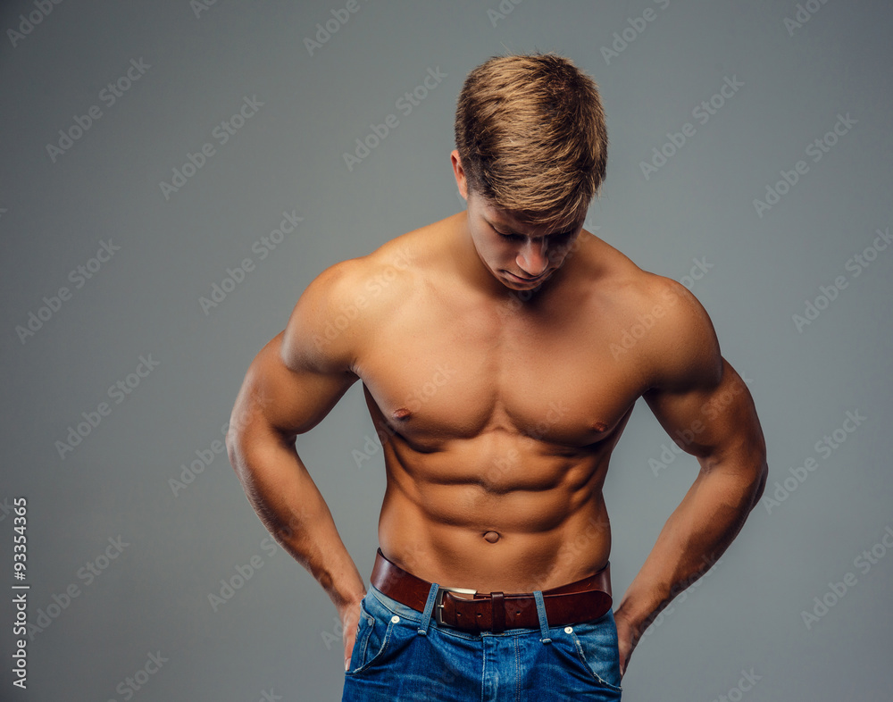 Fototapeta premium Young bodybuilder in denim jeans.