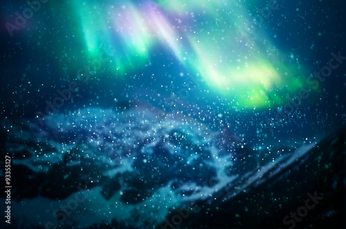 Fototapeta Naklejka Na Ścianę i Meble -  Snow falling against aurora borealis - focus on snowflakes