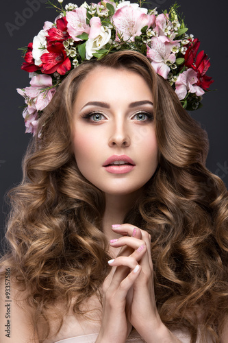 beautiful blond girl with curls and wreath of purple flowers on