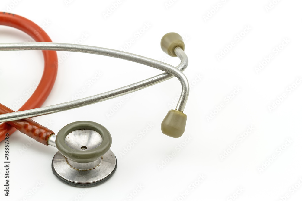 Close up earpiece and diaphragm of pink stethoscope on white bac Close up earpiece and diaphragm of pink stethoscope on white bac