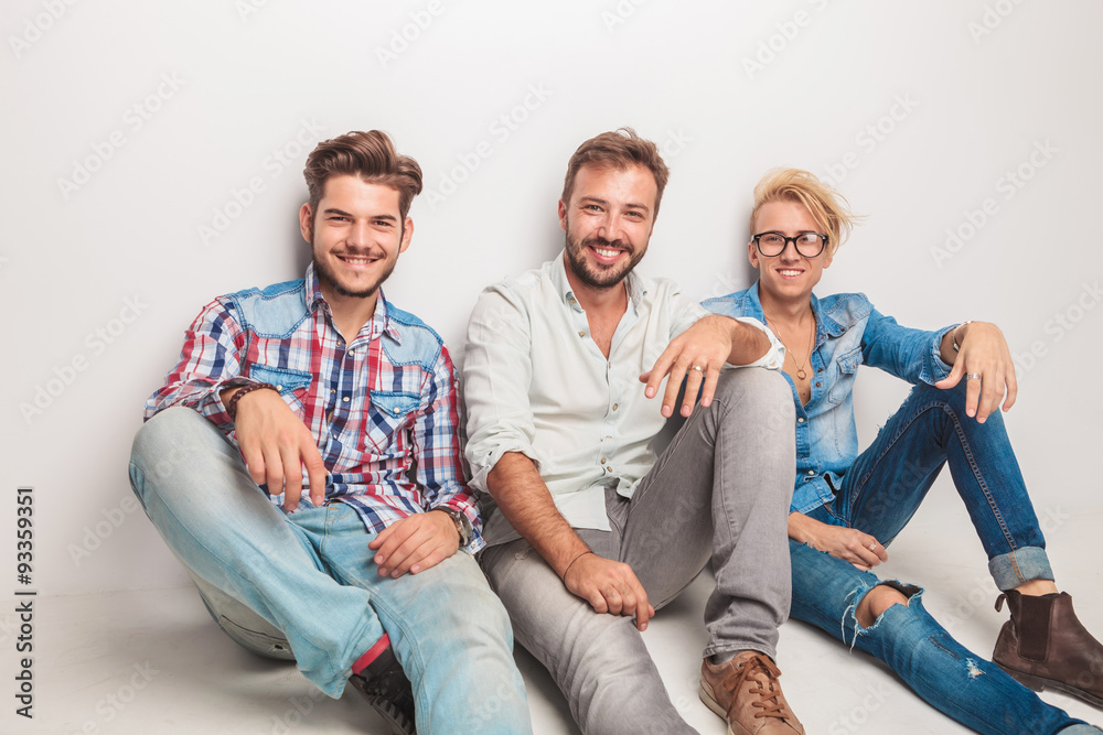 happy group of men laughing for the camera while sitting