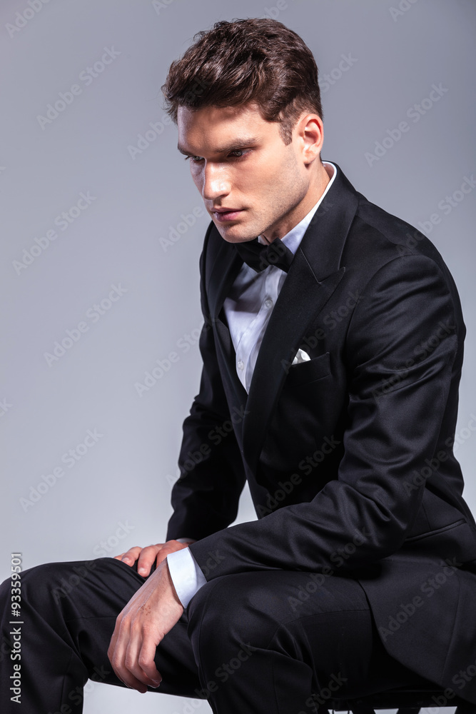 business man looking down while sitting. business man looking down while sitting.