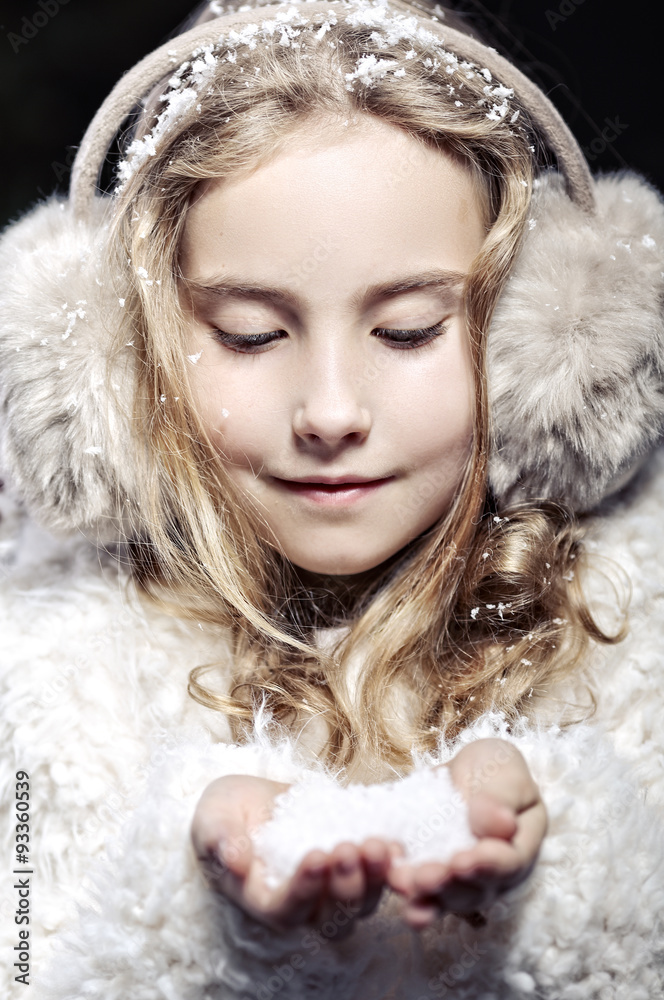 The girl in fur earmuffs in winter evening - obrazy, fototapety, plakaty 