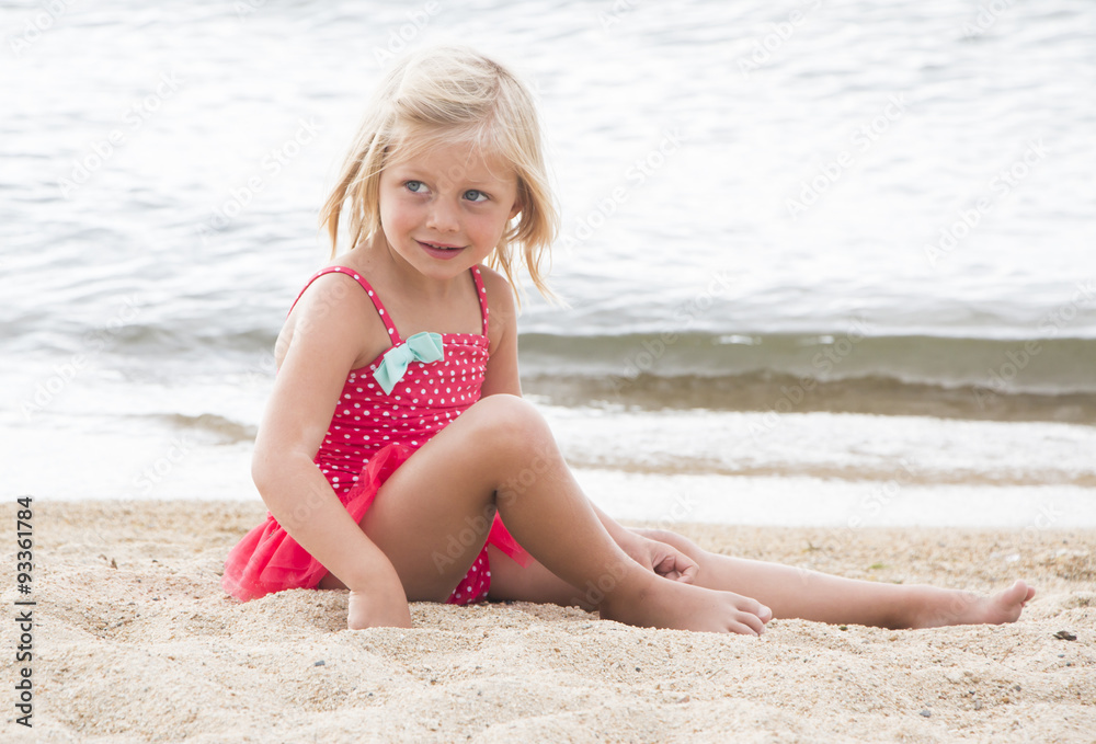 Little Girl Sunbathing on the Beach Little Girl Sunbathing on the Beach