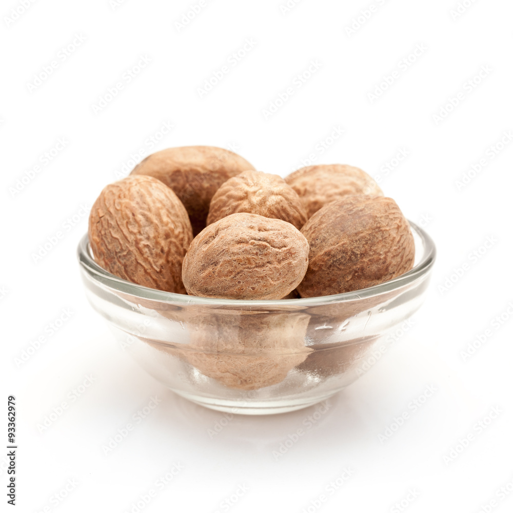 Front view of Organic Nutmeg Seed or Jaiphal (Myristica fragrans) in glass bowl isolated on white background. Front view of Organic Nutmeg Seed or Jaiphal (Myristica fragrans) in glass bowl isolated on white background.