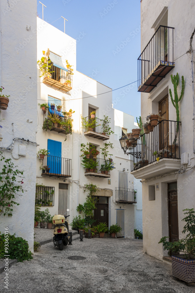 Narrow street with white houses. Mediterranean style Spain