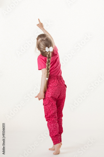 Photography Barefooted little girl turning back and indicating something up