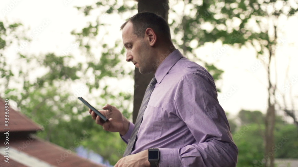 Young businessman using smartphone on terrace, slow motion 240fps
Young businessman using smartphone on terrace, slow motion 240fps
