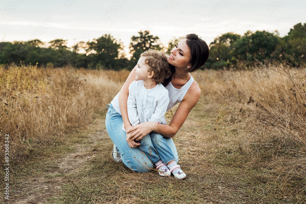 mother and daughter playing on autumn field together, loving family having fun outdoors mother and daughter playing on autumn field together, loving family having fun outdoors
