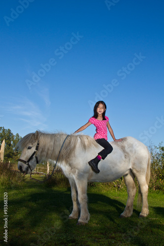Girl ridding a white horse in denmark