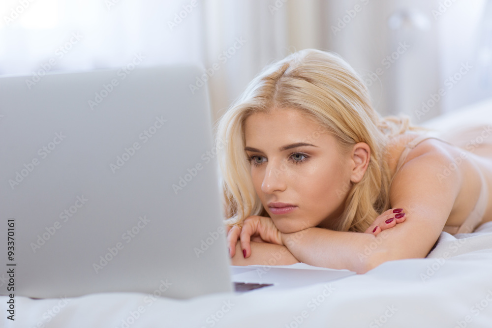 Portrait of a beautiful blonde woman using laptop Portrait of a beautiful blonde woman using laptop