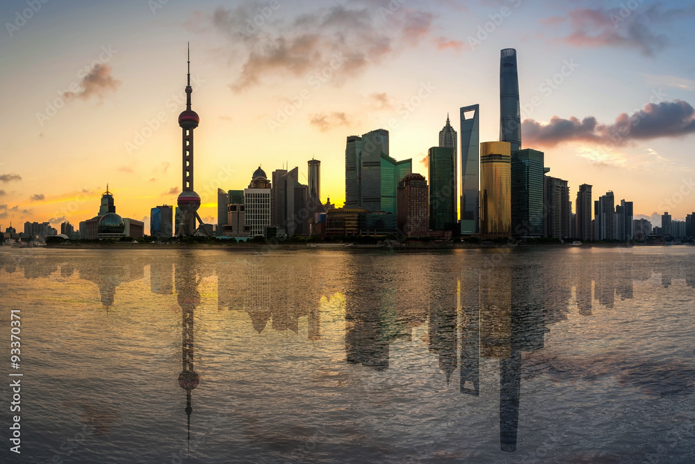 Shanghai, China city skyline on the Huangpu River at sunrise with reflection