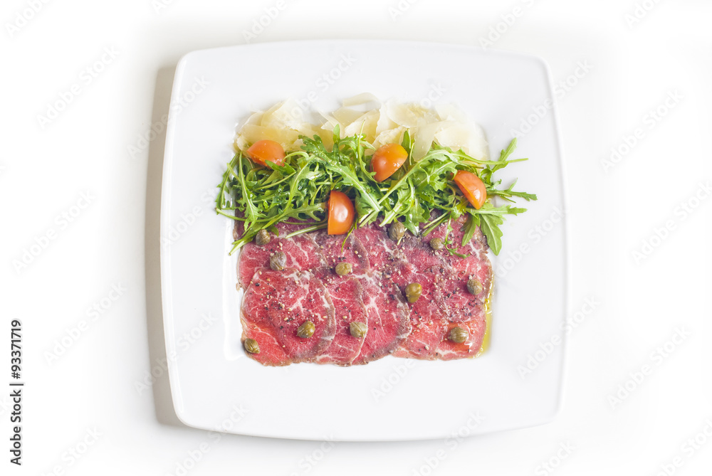 Carpaccio with parmesan cheese, arugula and capers