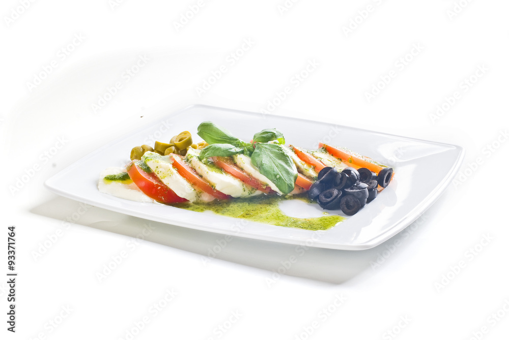 Caprese salad with tomato and mozzarella on white background