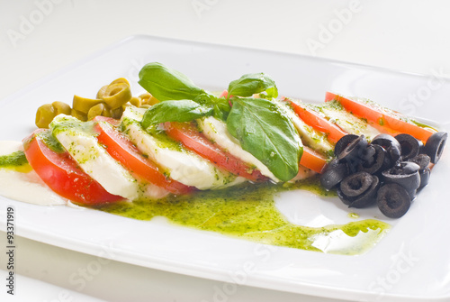 Obraz na płótnie Caprese salad with tomato and mozzarella on white background w salonie