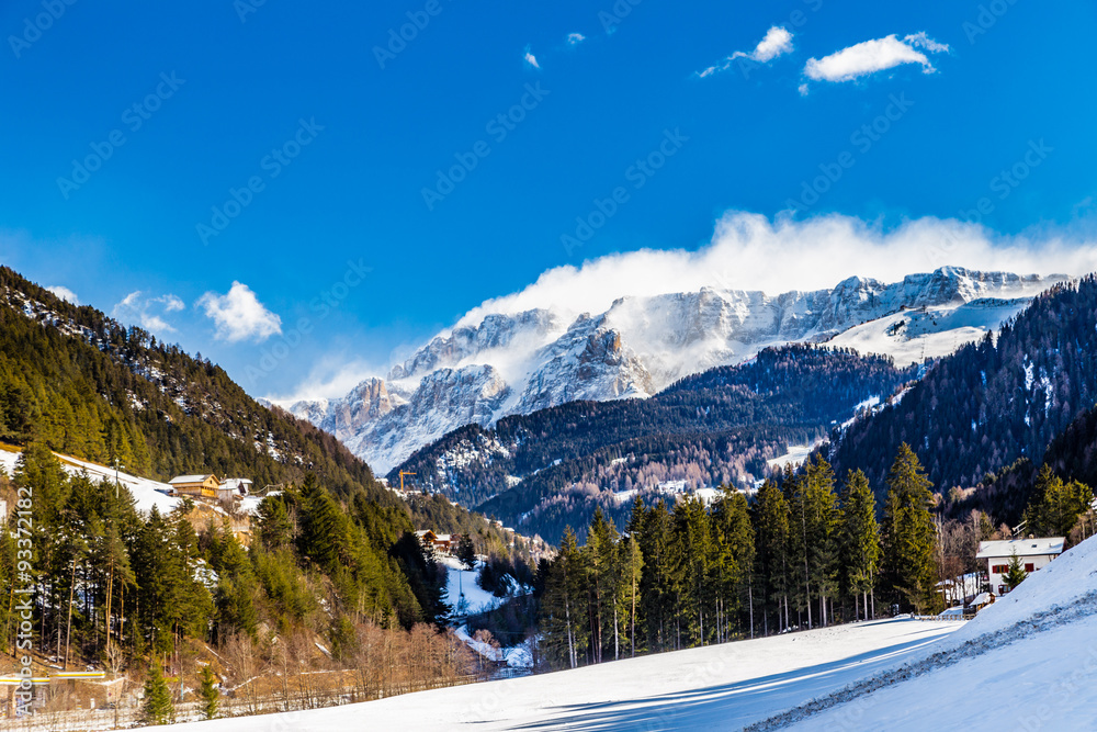 Dolomite mountains covered with white snow and green conifers Dolomite mountains covered with white snow and green conifers