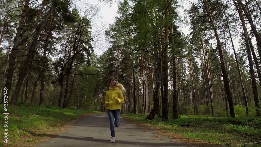 The woman runs on the forest road. Slow motion
The woman runs on the forest road. Slow motion
