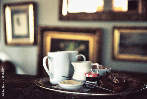 A historic late 18th century house interior, now a hotel and a restaurant.  A tea tray on a table in a room full of pictures. 