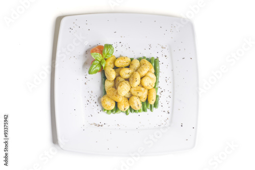 Obraz na płótnie Gnocchi on green beans with tomato w salonie