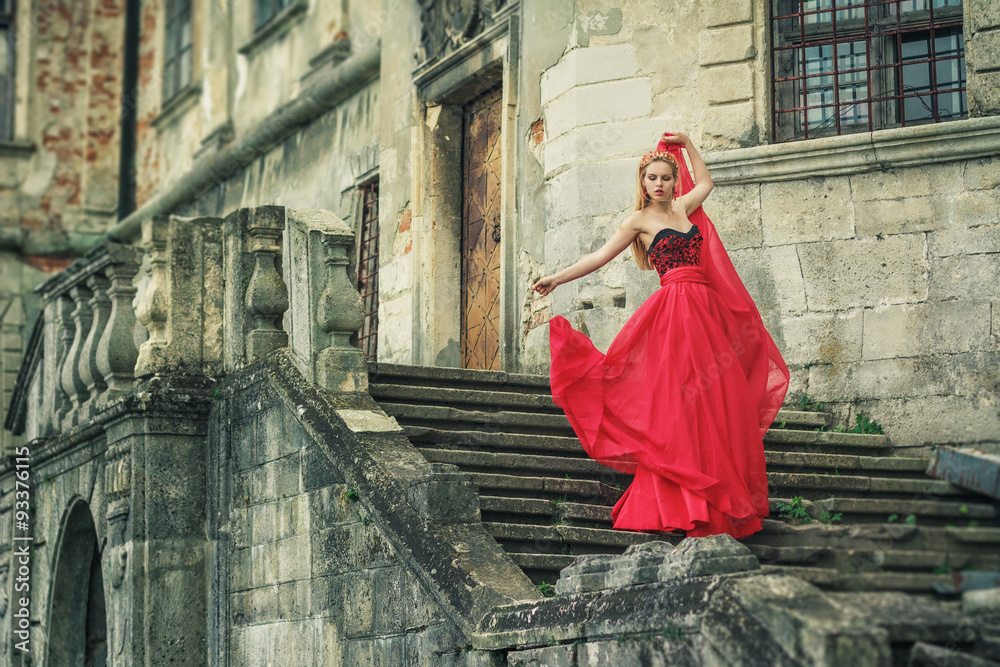 Beautiful young woman in fashion red dress