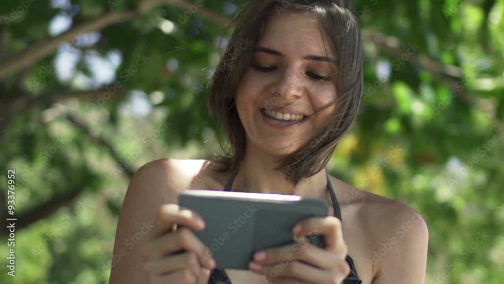 Young, happy woman playing game on smartphone in park, slow motion 240fps
Young, happy woman playing game on smartphone in park, slow motion 240fps
